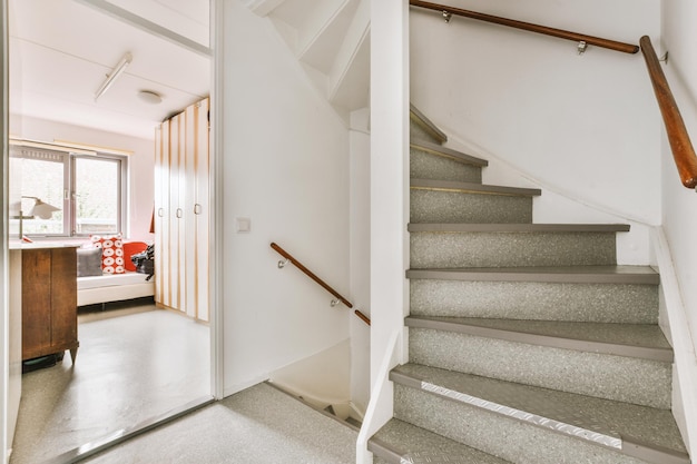 Wooden staircase in spacious hall of apartment