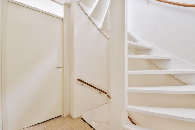 Wooden staircase in spacious hall of apartment