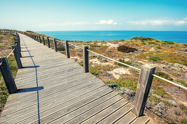 The wooden stairway at the rocky seashore on a sunny day Polvoeira the beach Pataias Portugal Europe