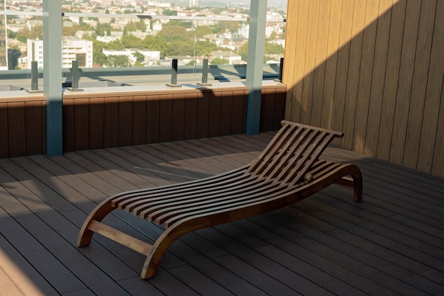 Wooden sun lounger on the roof of the penthouse overlooking the city Soft selective focus