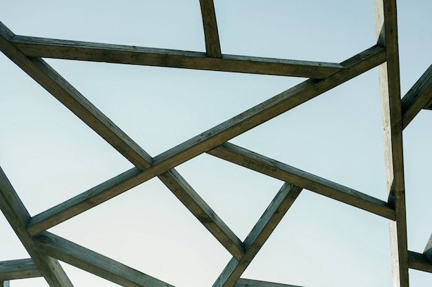 Wooden sunshade roof structure under blue sky at sunny summer day