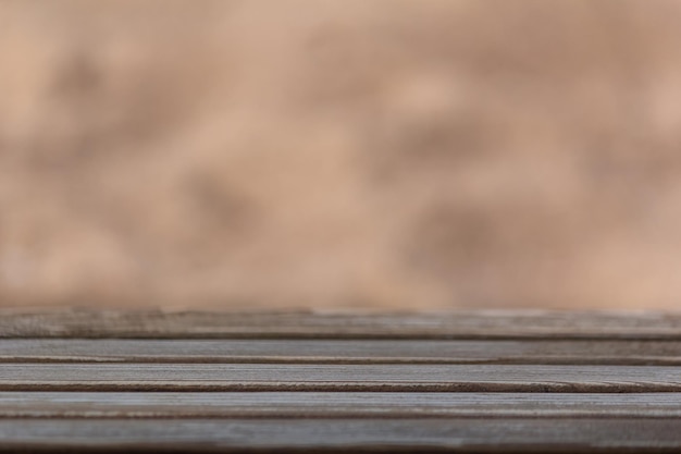 Wooden surface on a beige background of sand