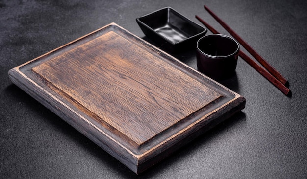 Wooden sushi sticks on a dark concrete background