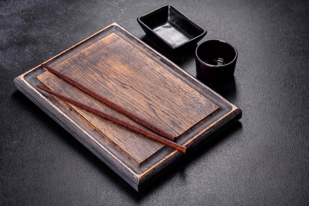 Wooden sushi sticks on a dark concrete background