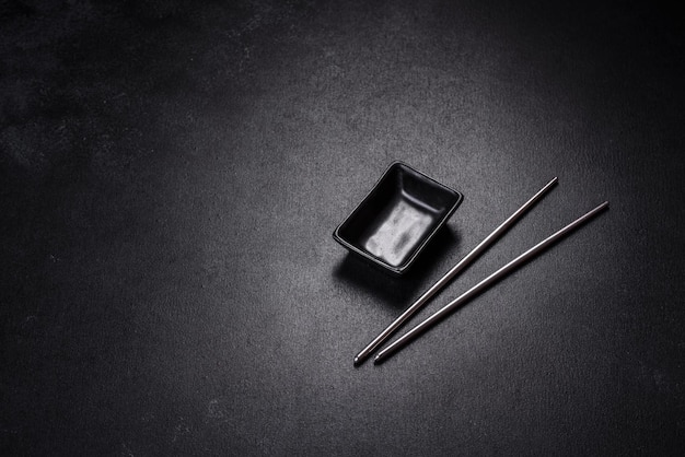 Wooden sushi sticks on a dark concrete background