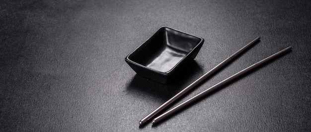 Wooden sushi sticks on a dark concrete background