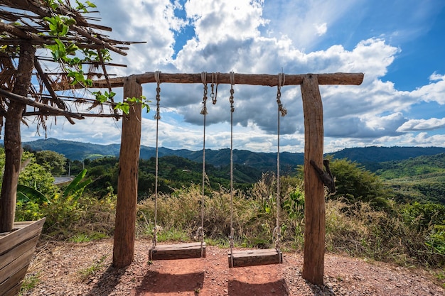 Wooden swing with beautiful landscape view and the valley of the mountain