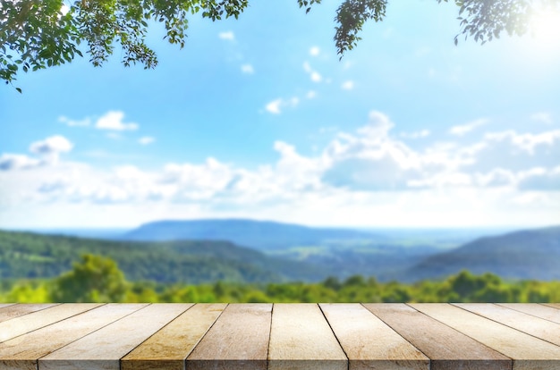 Wooden table against mountain landscape