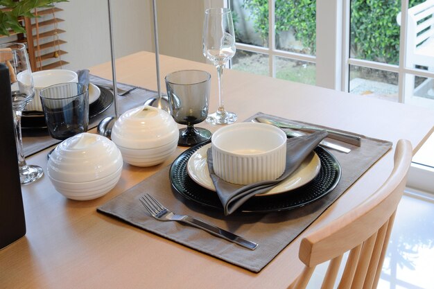 Wooden table in dining room with elegant table setting