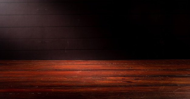 Wooden table in front of rustic wall with empty copy space