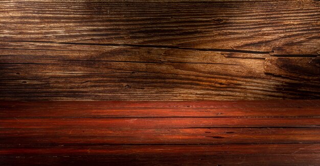 Wooden table in front of rustic wall with empty copy space