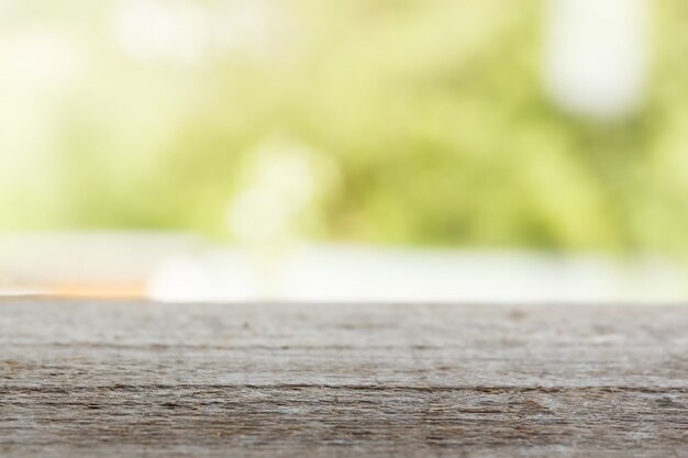 Wooden table on a green background. Copy space.