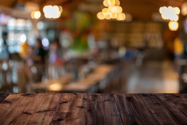 A wooden table on a restaurant blurred background