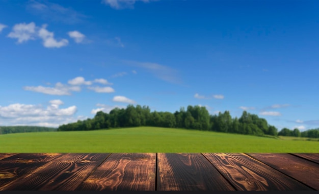 Wooden table on summer field nature background Showing product on blurred countryside farm landscape