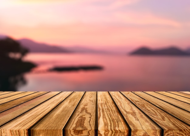 Wooden table top on blurred scene colorful sky on the lake in countryside at evening background