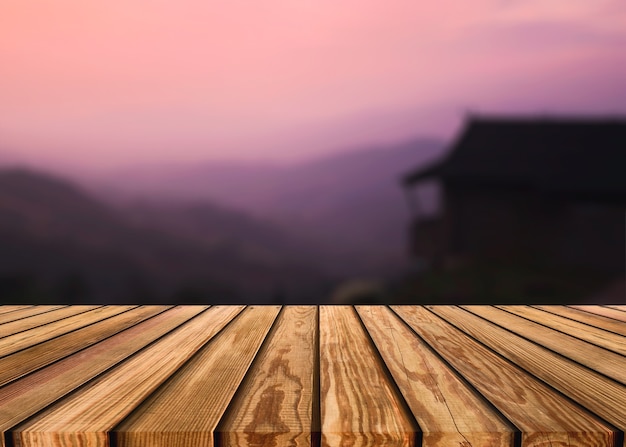 Wooden table top on blurred scene of resort with colorful sky and mountain at evening