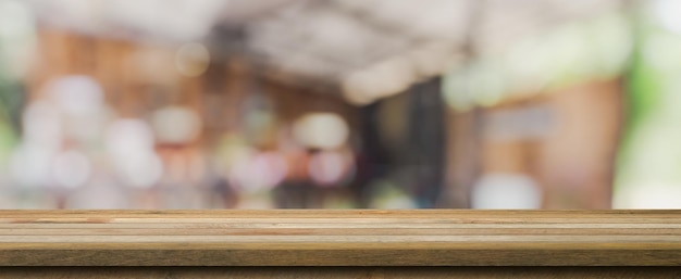 Wooden table top with blurred people in coffee shop and cafe background for display montage copy space