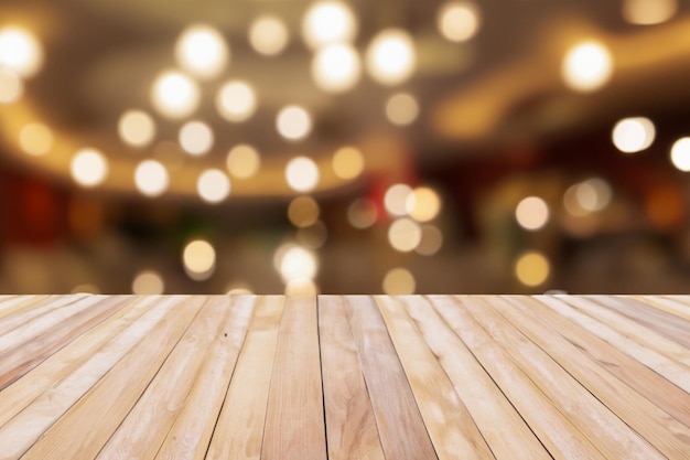 Wooden table top with blurry background of bright lights