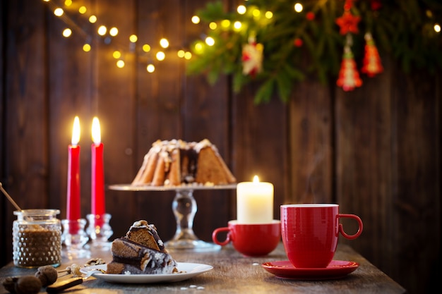 Wooden table with Christmas cake and decor