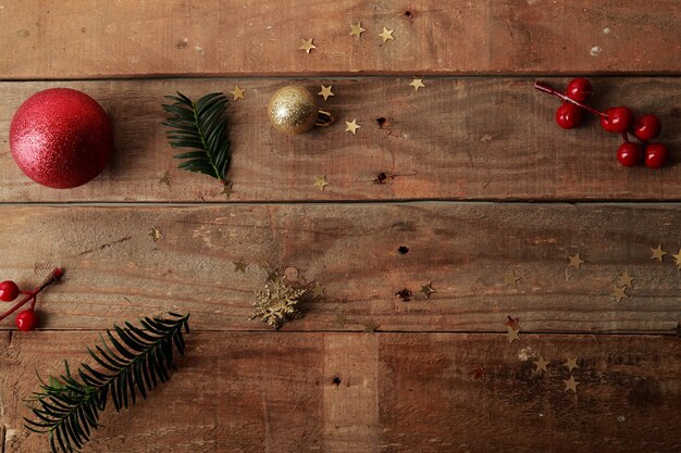 wooden table with small Christmas decorations for crafts placed in a disorderly way