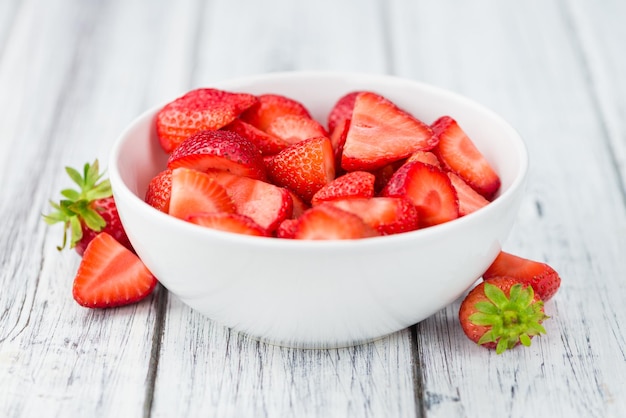 Wooden table with Strawberries Chopped selective focus