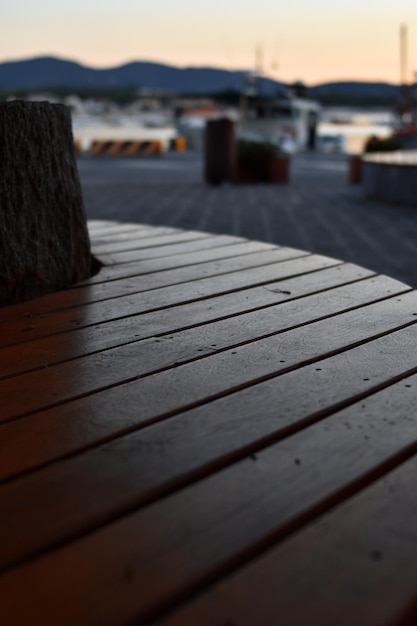 A wooden table with a tree in the background