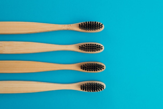 Wooden toothbrush on blue background