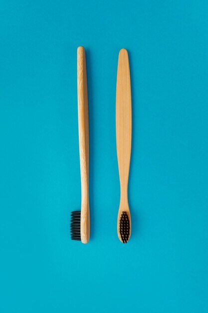 Wooden toothbrush on blue background