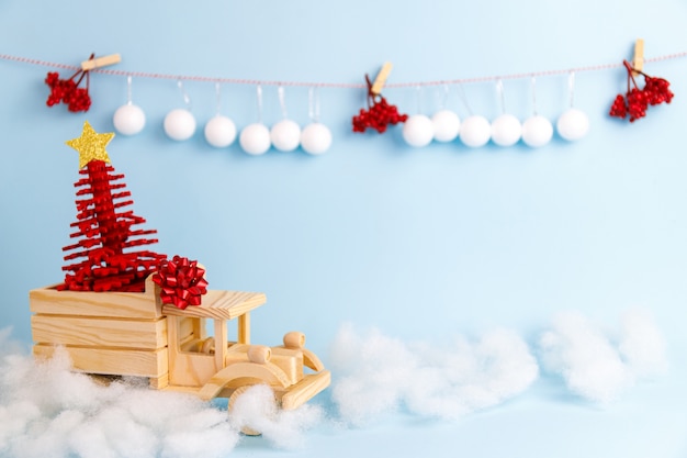 Wooden toy christmas car on blue background