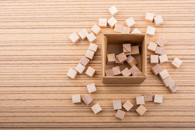 Wooden toy cubes as educational game object on wooden background