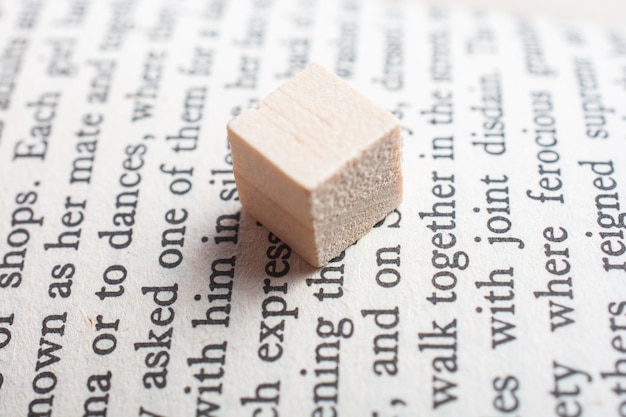 Wooden toy cubes placed on a book page