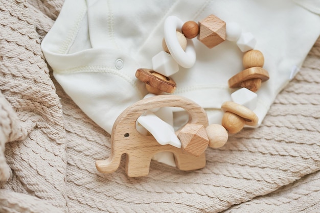 Photo wooden toys, rattles, teethers, nipple holder. baby development, fine motor skills. children and newborn products and accessories. kids clothes. wish list for pregnancy and baby shower.