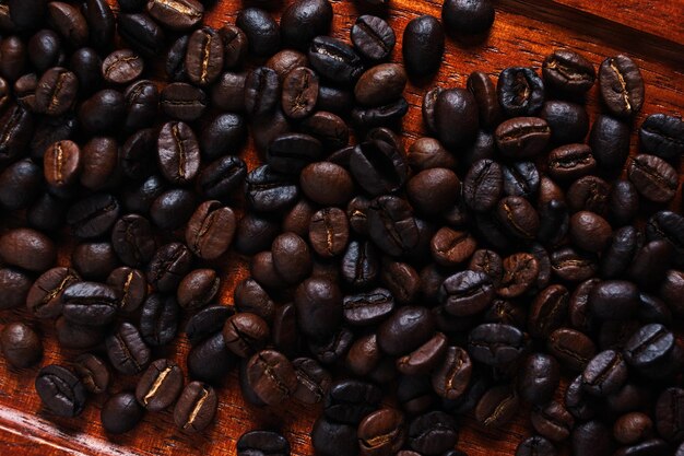 A wooden tray of coffee beans with the word coffee on it