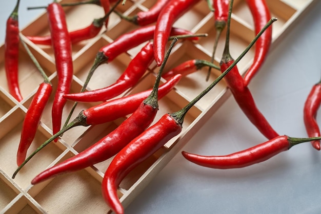 A wooden tray of red chili peppers