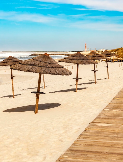 Wooden walkway and beach umbrellas