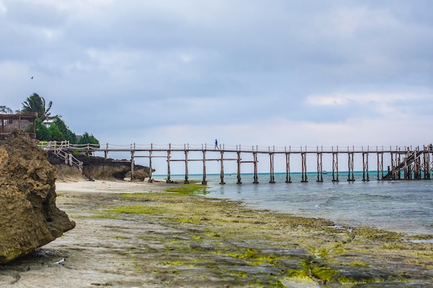 Wooden walkway stretching over the sea at sunrise, Nungwi, Zanzibar, Tanzania