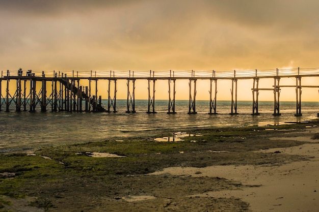 Wooden walkway stretching over the sea at sunrise, Nungwi, Zanzibar, Tanzania