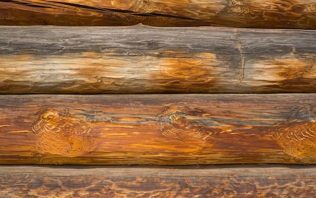 Wooden wall assembled from timber or logs Background of horizontal logs