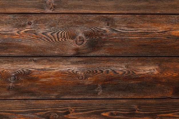 Wooden wall, brown striped timber desk, old table or floor