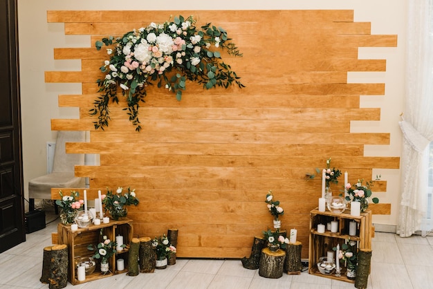 Wooden wall decorated flowers The arch for the ceremony is decorated with flowers and greens Wood wedding decor Original wedding floral decoration Reception Lounge zone in the banquet area