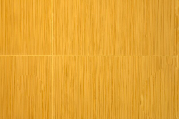 A wooden wall with a yellow background that says pasta on it.