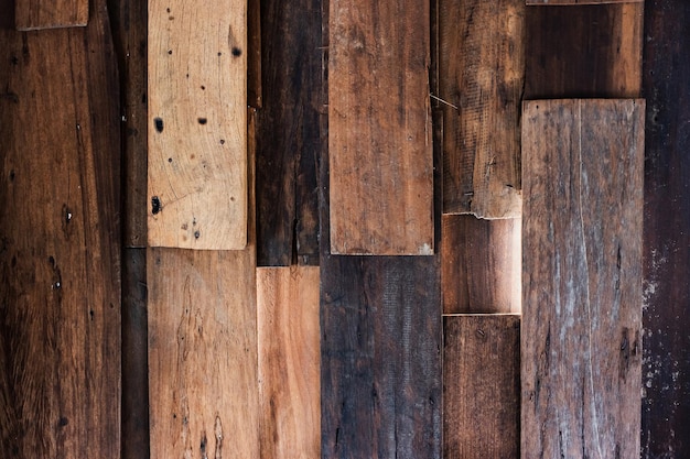 Wooden walls of an old house are decayed and light can penetrate