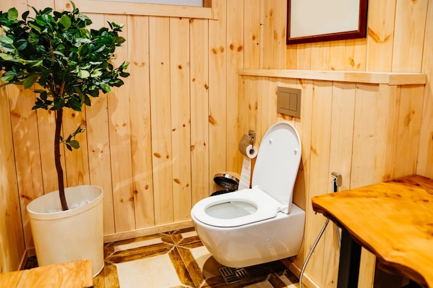 Wooden walls in the toilet ecofriendly design for a bathroom in a hotel or country house modern toilet indoor plants in the house