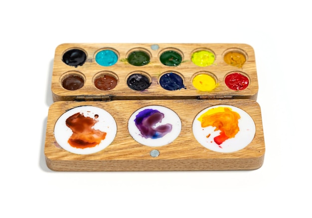 Wooden watercolor palette Watercolor tray with watercolor set isolated on a white background