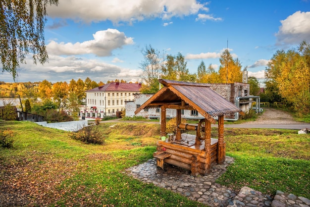 A wooden well and a landscape museum in the autumn Plyos