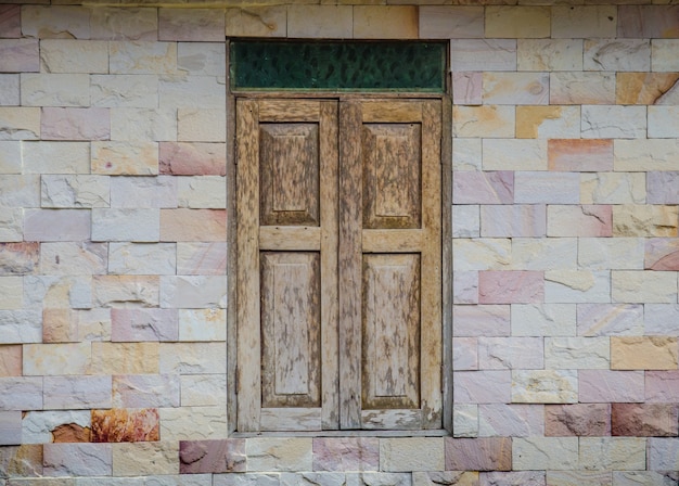 Wooden window on stone wall