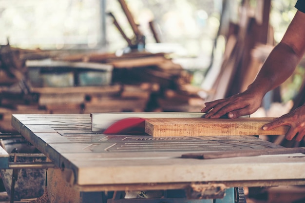 woodworking workshop: carpenters work table with different tools and wood cutting