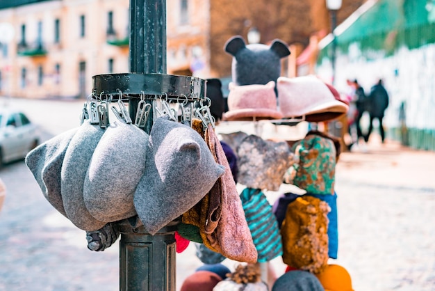 Wool hats sells outdoor on the city's street Urban Market Trading Trade Business Warm Different Illegal Pole Sidewalk Pavement