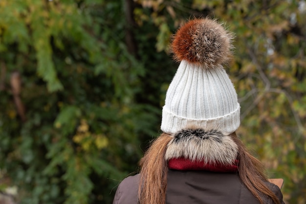 Woollen hat with tassel in brown colours autumn fashion concept