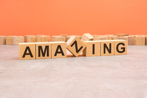 Word amazing made with wood blocks text is written in black letters light background